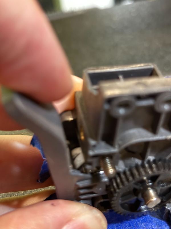 Extruder gear assembly being serviced