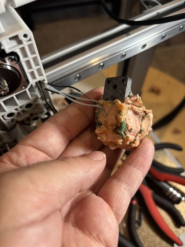 The blob removed in one piece, with the hotend and wiring still buried inside
